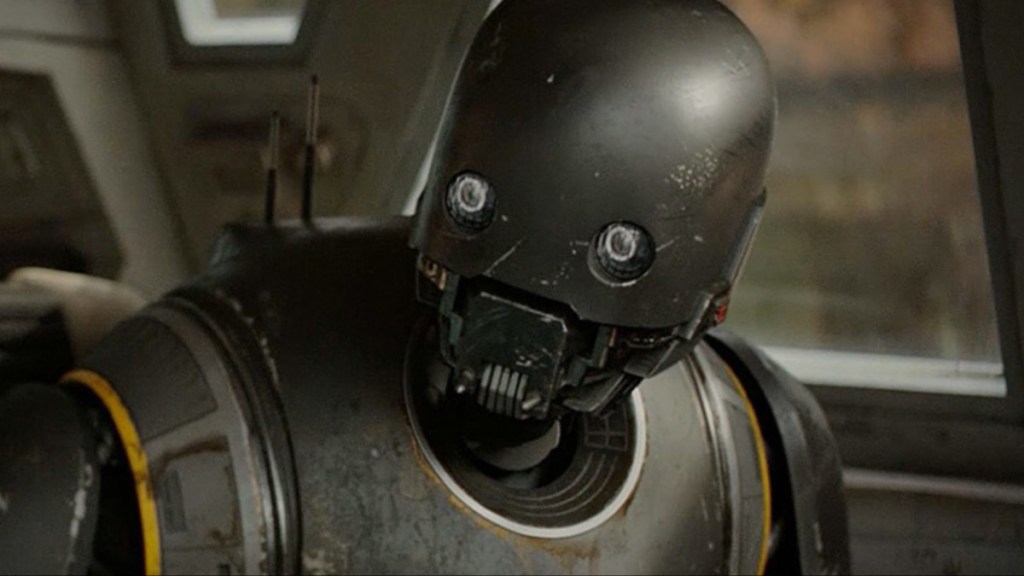 A droid named K-2SO turns and stares.
